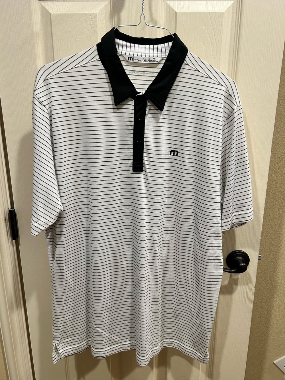 Travis Mathew White Polo with Black Collar and Stripes. Never worn but washed